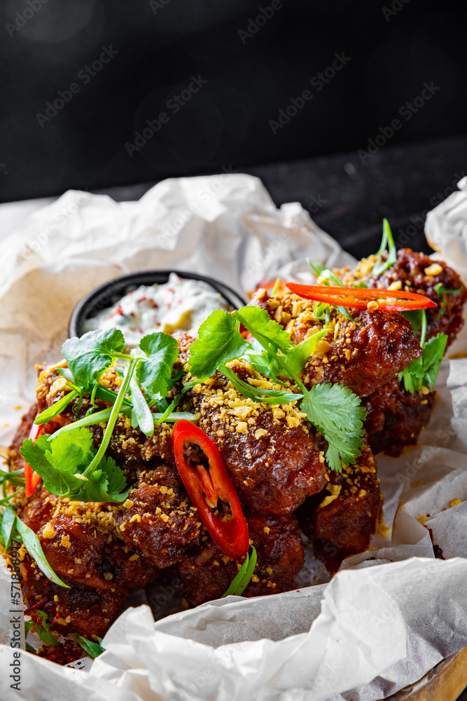 Poster fried bbq chicken wings in plate