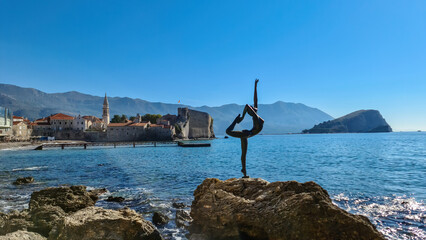 Ballerina statue (dancing girl) with panoramic view of the medieval old town of the coastal city of...