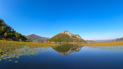 Scenic view of Lake Skadar National Park in autumn near Virpazar, Bar, Montenegro, Balkans, Europe. Travel destination in Dinaric Alps, Albanian border. Stunning landscape water reflection in nature