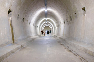 person walks through an abandoned tunnel that was built during World War II. the clothes are winter