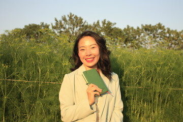 young charming Asian women with elegant style in roses garden
