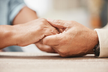 Fototapeta premium Support, praying or old couple love holding hands together in a Christian home in retirement with hope, belief or faith. Jesus, senior man and woman with peace in prayer to God for spiritual bonding