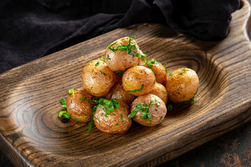 Baby round potatoes cooked with herbs and vegetable oil. Garnish of small young potatoes