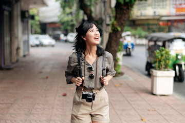 Fototapeta premium Young Asian woman backpack traveler enjoying street cultural local place and smile. Traveler checking out side streets.