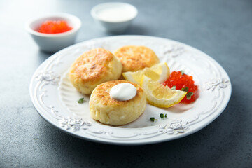 Homemade potato cakes with red caviar and lemon