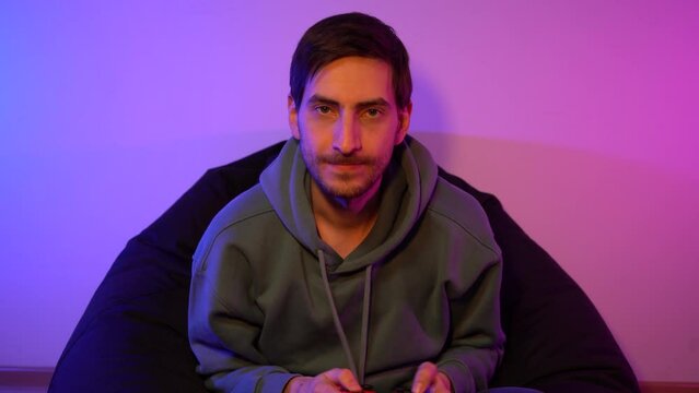 Exicted male cybersport gamer playing game with controller
