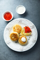 Homemade potato cakes with red caviar and lemon