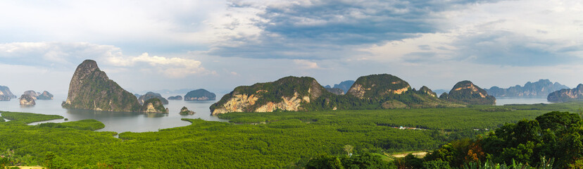 Fototapeta na wymiar Top view on Phang nga bay. Samet Nangshe view point. High angle view of breathtaking limestone islands surrounding with emerald green water in blue sky summer. Panorama background.