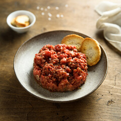Homemade steak tartare with baguette bread