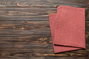 top view with red empty kitchen napkin isolated on table background. Folded cloth for mockup with...