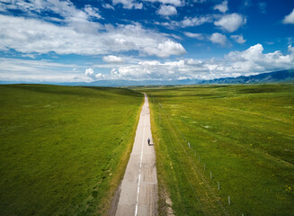 Man ride bicycle on the mountain road top view