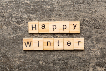 Happy winter word written on wood block. Happy winter text on cement table for your desing, concept