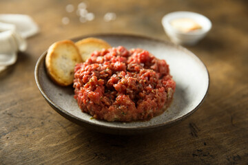 Homemade steak tartare with baguette bread