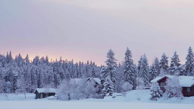 Cozy Cabins At Sunset Surrounded By Snow-covered Forest In Winter In Indre Fose, Trondelag, Norway. timelapse