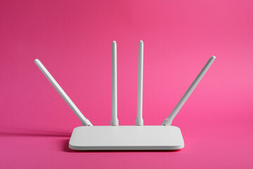 New white Wi-Fi router on pink background - obrazy, fototapety, plakaty