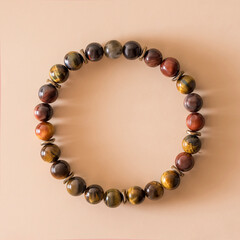 bracelet made of Tiger's eye and bull's eye stones for businessmen and people in the field of finance. They give energy, confidence and good luck in any activity. beige background.