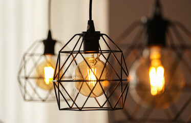 Decorative antique edison style light bulbs inside a modern apartment. Light inside the living room.