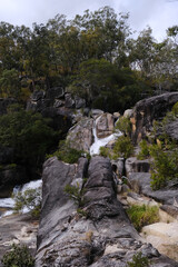 Fototapeta na wymiar Waterfall scenery in the tropics with lots of green and rocks