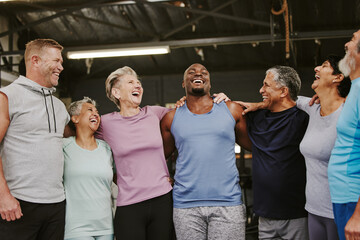 Senior workout group, laugh and personal trainer, smile or support for wellness goal. Elderly women, team building and happy at gym for friends, solidarity and diversity for teamwork motivation hug
