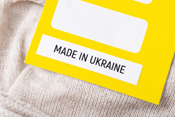 Close up on label on socks with inscription Made in Ukraine. Making clothes in Ukraine