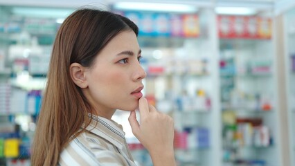 A woman customer standing and looking products medicines or supplements in the pharmacy