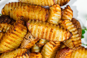 Baked potato slices on a dark background