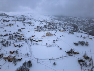 Winter Landscape with Small Village Houses Between Snow Covered Forest in Cold Mountains. Giresun - Turkey