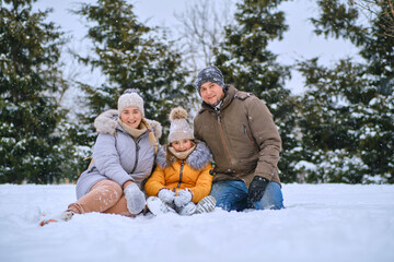 happy kid and parents in the winter