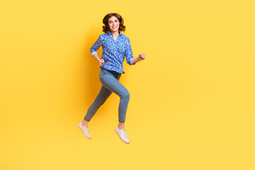 Fototapeta na wymiar Full length profile photo of active sportive person running rush jumping isolated on yellow color background