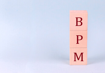 BPM on wooden cubes on a blue background