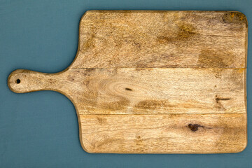 Shabby cutting board on the blue fabric backdrop.