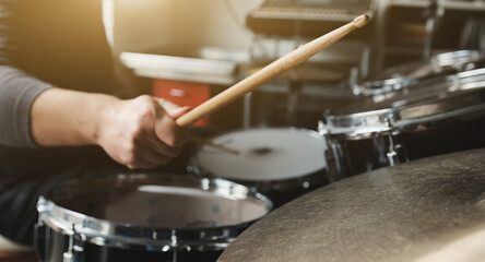 Drummer playing on drums and bronze cymbal plates with drumsticks live music. Musician during percussion instrumental perfomance