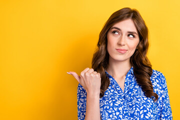Photo of young funny smart business lady minded thinking look empty space direct finger genius idea buy new offer isolated on yellow color background