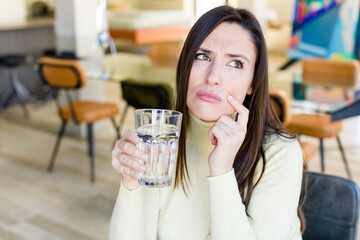 young adult woman with a water glass