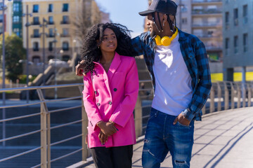 Fototapeta premium Young african american women in the city, lifestyle friends concept, smiling embracing