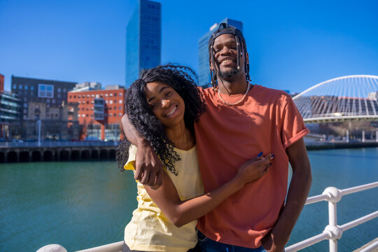 Young African American couple in the city, lifestyle friends concept, portrait embracing smiling