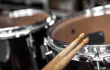 Fototapeta na wymiar Drumsticks and drums for live music rock perfomance closeup. Wooden musical sticks for percussion instruments