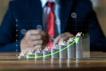 Businessman putting down money, pointing with pen and showing candlestick symbol for investing,...