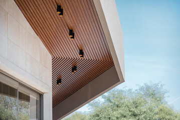 PVC ceiling panel covered with wood-like vinyl with modern lighting installed on it