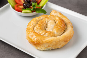 Traditional Turkish pastry made with spinach and cheese wrapped in phyllo. Turkish name gul boregi...
