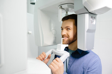 Panoramic image of teeth. A patient in a modern dental clinic takes a panoramic picture of the...