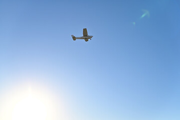 Plane takes off from the runway from International Airport de Cascais, blue sky background.