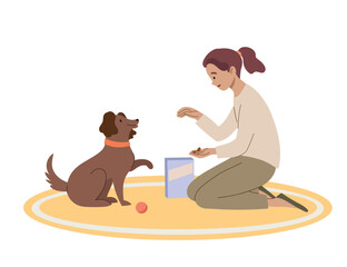 Girl gives friendly dog a treat. The owner trains pet to give a paw.