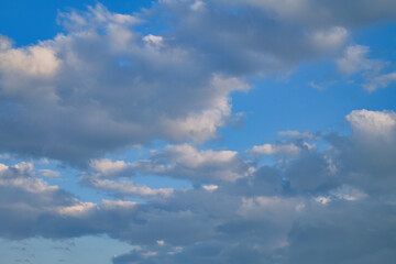 Summer evening sky in the picturesque clouds, lit by the rays of the setting sun.