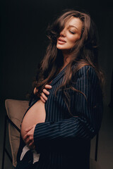 Fashion photo of a pregnant woman.Pregnancy, motherhood, preparation and waiting for childbirth