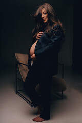 Obraz na płótnie Canvas Fashion photo of a pregnant woman.Pregnancy, motherhood, preparation and waiting for childbirth