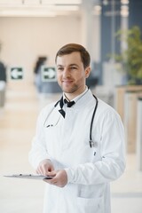 Portrait of smiling doctor in uniform standing in medicine clinic hall