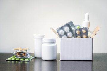 medicinal pills and tablets in box and on the wooden table. concept medicine.