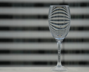 front view shot of a champagne or wine glass with a glass sphere. black and white striped...