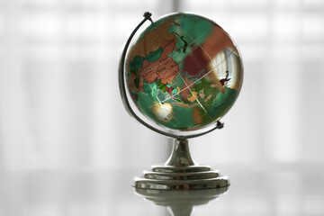 Map of Asia on a crystal globe. isolated on white background. blue glass globe on white backdrop. white transparent crystal earth isolated on white background. Globe of the World. Asia.